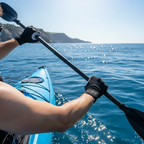 Black fingerless gloves worn by kayaker on open ocean